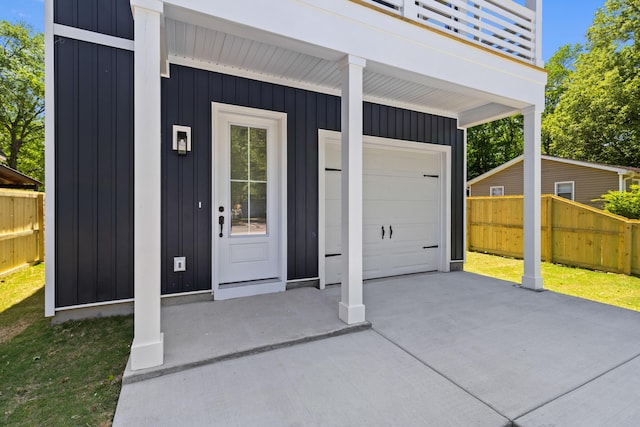1917 Jason St, North Charleston, SC 29406 - doorway to property featuring a garage, fence, a balcony, board and batten siding, and driveway
