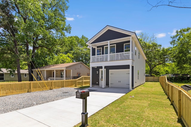 1917 Jason St, North Charleston, SC 29406 - view of front of home with covered porch, driveway, a garage, a balcony, and a front lawn