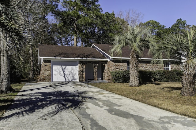 ranch-style home featuring a front yard and a garage