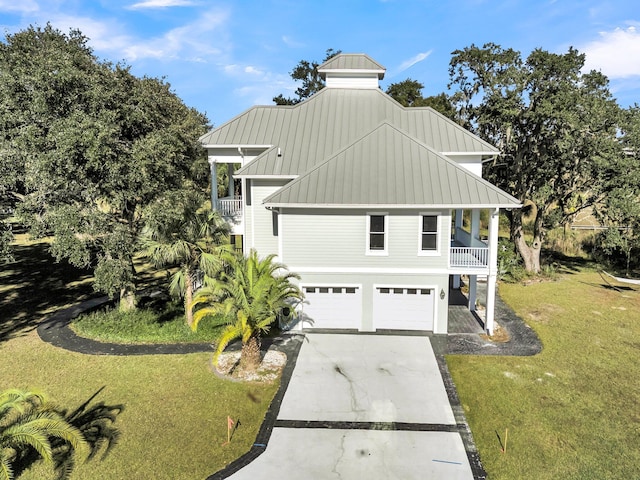 view of front of house with a front yard, a balcony, and a garage