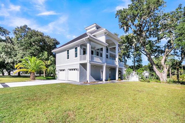 view of side of property with a garage, a yard, and a balcony