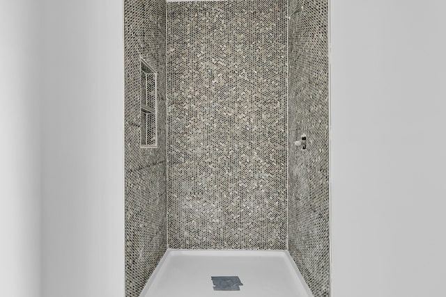 bathroom with tiled shower