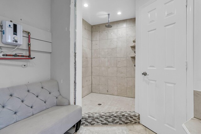 bathroom featuring tile patterned floors, water heater, and tiled shower