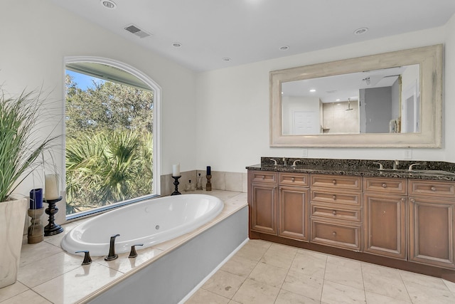 bathroom featuring vanity, tile patterned floors, and a bathing tub