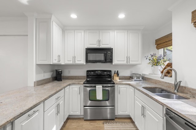 kitchen with white cabinetry, sink, and stainless steel appliances