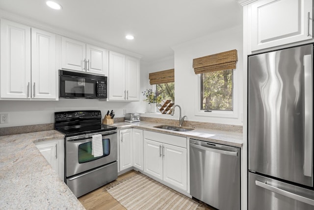 kitchen featuring white cabinetry, appliances with stainless steel finishes, and sink