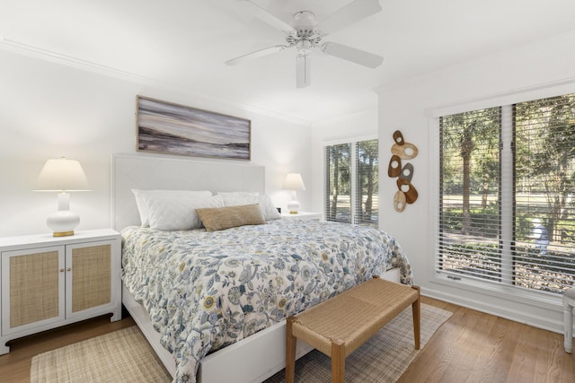 bedroom featuring crown molding, ceiling fan, hardwood / wood-style floors, and access to outside