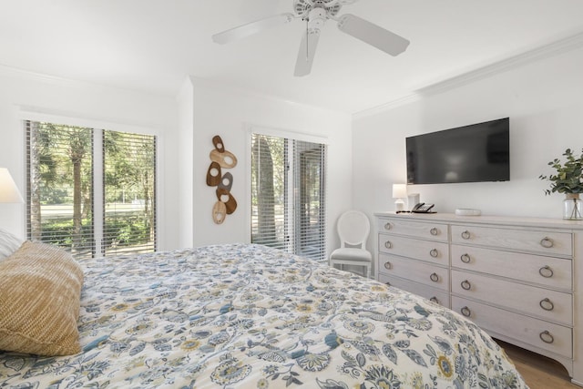 bedroom featuring wood-type flooring, crown molding, access to outside, and ceiling fan