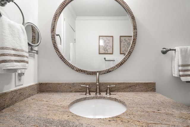 bathroom with ornamental molding and vanity