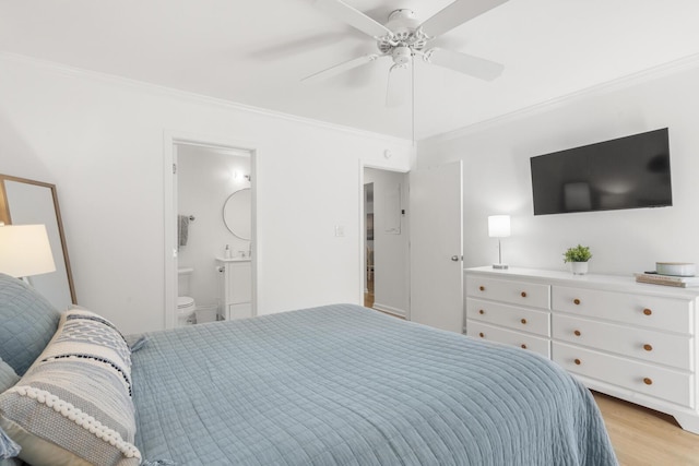 bedroom with crown molding, ensuite bath, ceiling fan, and light hardwood / wood-style flooring