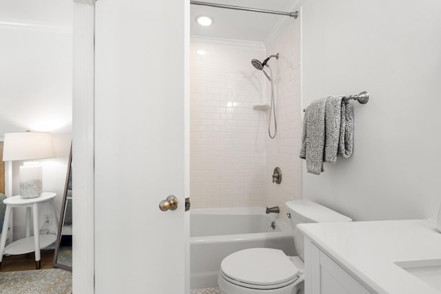 full bathroom with tiled shower / bath combo, vanity, crown molding, and toilet