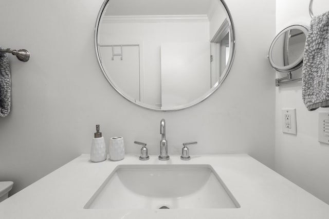 bathroom featuring ornamental molding and vanity