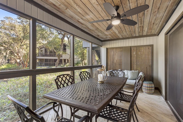 sunroom / solarium with wooden ceiling and ceiling fan