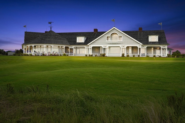 view of front of home with a garage and a lawn