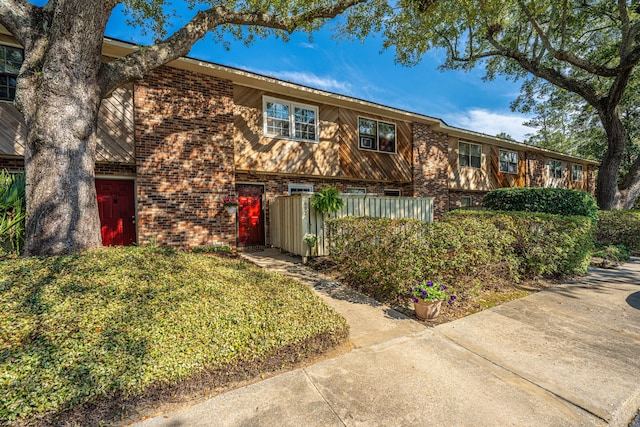 view of property featuring brick siding