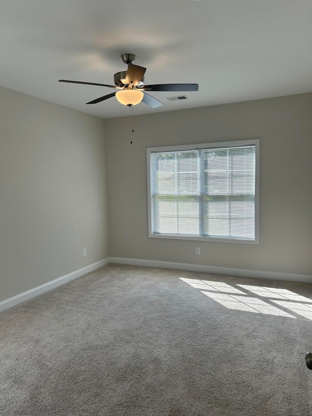 empty room featuring ceiling fan and carpet floors