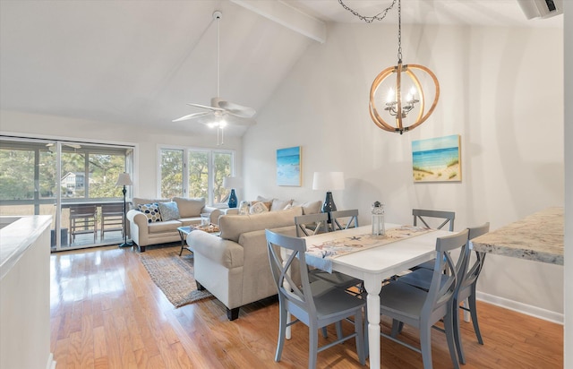 dining room with beam ceiling, light wood-type flooring, ceiling fan with notable chandelier, and high vaulted ceiling