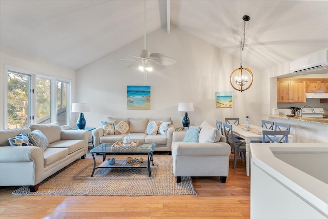 living room featuring an AC wall unit, ceiling fan with notable chandelier, vaulted ceiling with beams, sink, and light hardwood / wood-style flooring