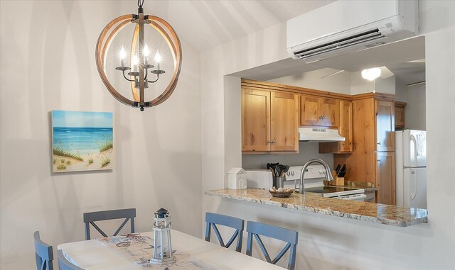 kitchen with light stone counters, a breakfast bar, white appliances, and a wall mounted air conditioner