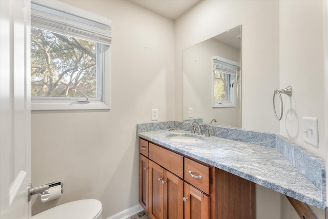 bathroom featuring toilet and vanity