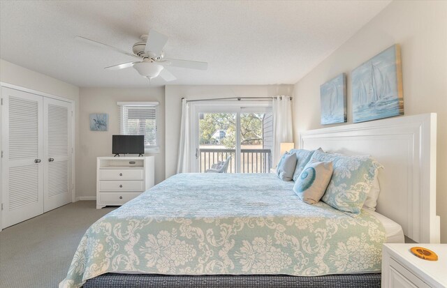 bedroom featuring ceiling fan, access to outside, a closet, light colored carpet, and a textured ceiling