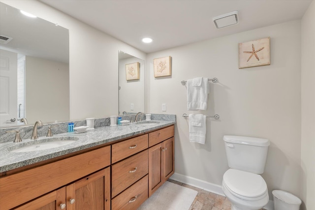 bathroom featuring toilet and vanity