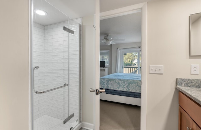 bathroom featuring ceiling fan, walk in shower, and vanity