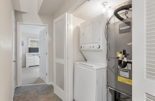 laundry room with stacked washer / drying machine