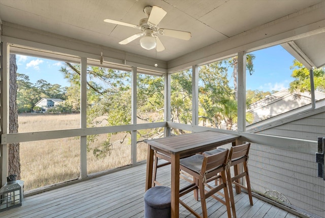 sunroom / solarium featuring ceiling fan and plenty of natural light