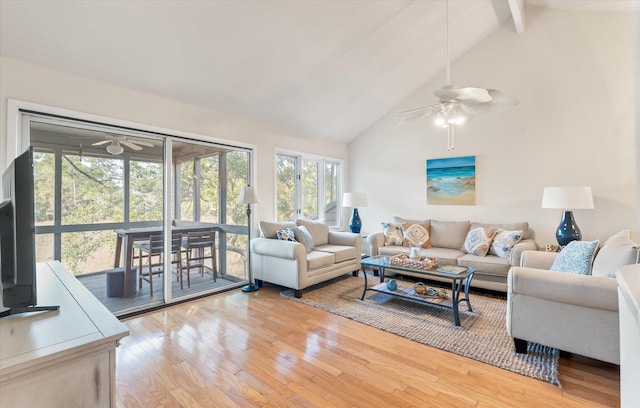 living room with ceiling fan, beam ceiling, hardwood / wood-style flooring, and high vaulted ceiling