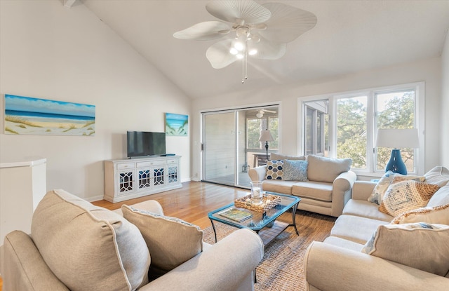 living room featuring vaulted ceiling, ceiling fan, and hardwood / wood-style flooring