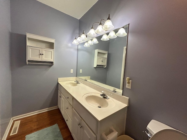 236 Chamblee Rd, Walterboro, SC 29488 - bathroom with wood finished floors, double vanity, toilet, and baseboards