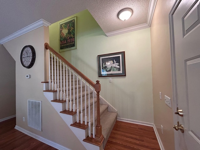 236 Chamblee Rd, Walterboro, SC 29488 - stairway featuring wood finished floors, a textured ceiling, ornamental molding, and baseboards