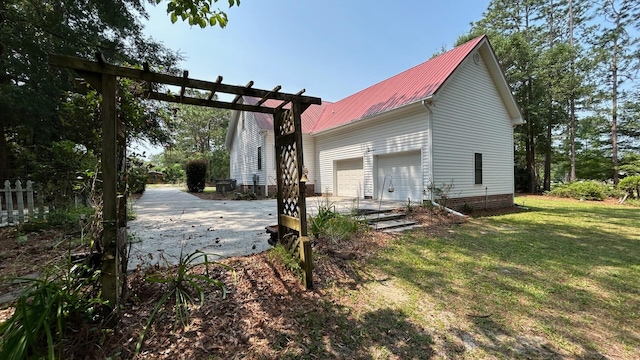 236 Chamblee Rd, Walterboro, SC 29488 - view of home's exterior with metal roof, driveway, a lawn, and a garage