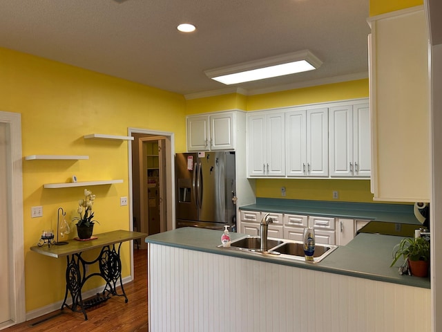 236 Chamblee Rd, Walterboro, SC 29488 - kitchen with stainless steel refrigerator with ice dispenser, a sink, white cabinets, dark wood-style floors, and a peninsula