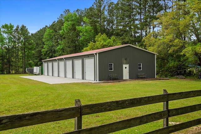 view of outbuilding featuring a lawn and a garage