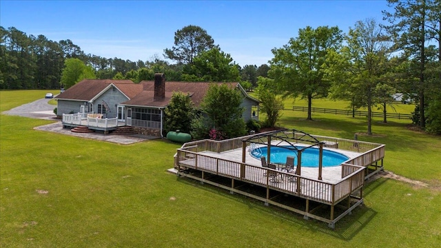 view of swimming pool with a patio, a deck, and a lawn