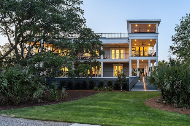 2213 Rolling Dune Rd, Seabrook Island, SC 29455 - back of property with a balcony, ceiling fan, a lawn, french doors, and stairs