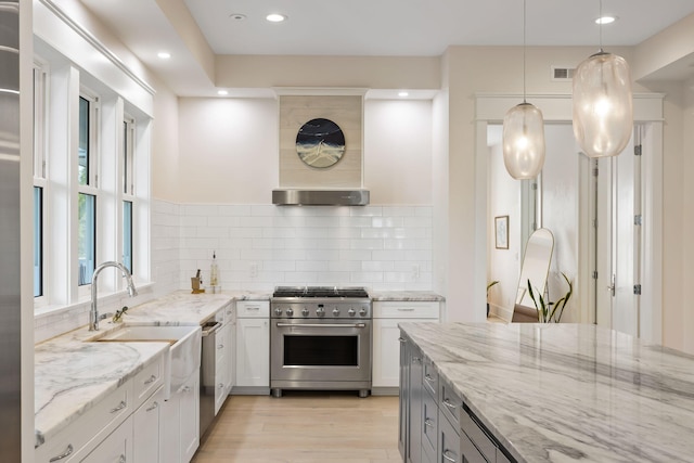 2213 Rolling Dune Rd, Seabrook Island, SC 29455 - kitchen featuring appliances with stainless steel finishes, backsplash, light stone countertops, light wood-type flooring, and recessed lighting