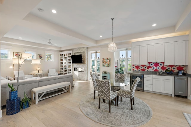 2213 Rolling Dune Rd, Seabrook Island, SC 29455 - dining space with beverage cooler, a tray ceiling, light wood-style flooring, plenty of natural light, and recessed lighting
