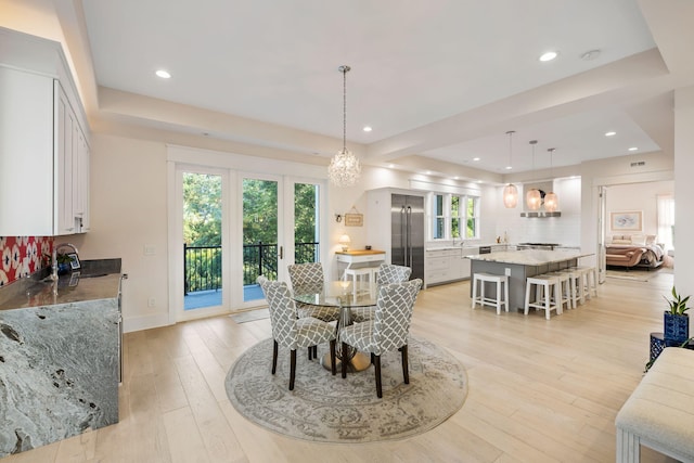 2213 Rolling Dune Rd, Seabrook Island, SC 29455 - dining room with a tray ceiling, light wood-type flooring, recessed lighting, a chandelier, and baseboards