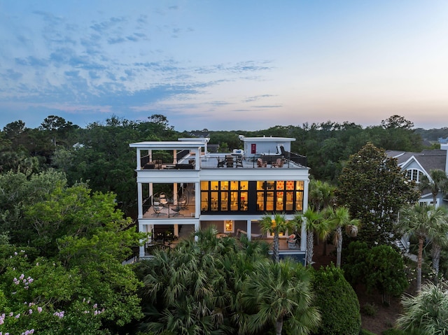 2213 Rolling Dune Rd, Seabrook Island, SC 29455 - back of property at dusk featuring a balcony