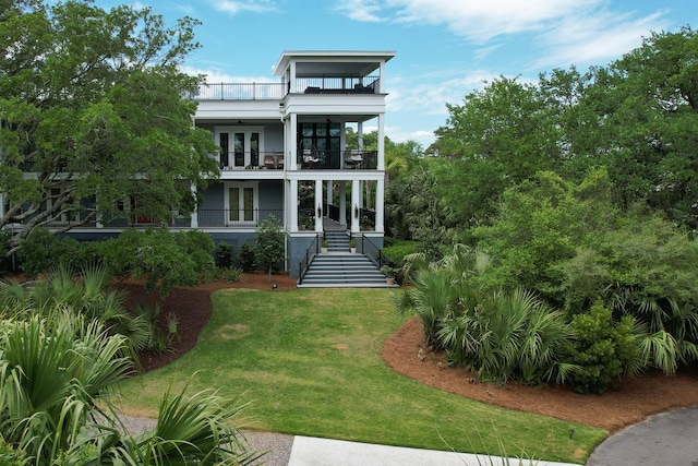 2213 Rolling Dune Rd, Seabrook Island, SC 29455 - view of front facade with french doors, a balcony, stairway, and a front lawn
