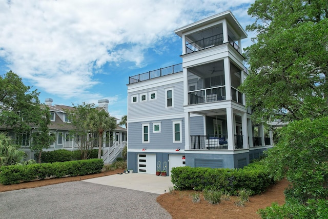 2213 Rolling Dune Rd, Seabrook Island, SC 29455 - view of front of home with a balcony, asphalt driveway, a garage, and stucco siding