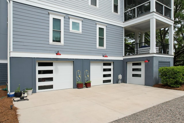 2213 Rolling Dune Rd, Seabrook Island, SC 29455 - view of side of property featuring a balcony, concrete driveway, and an attached garage