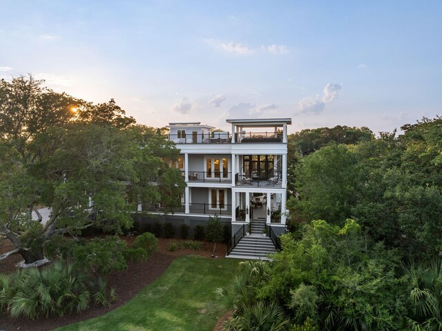 2213 Rolling Dune Rd, Seabrook Island, SC 29455 - view of front of property with a balcony, french doors, stairs, and a front yard