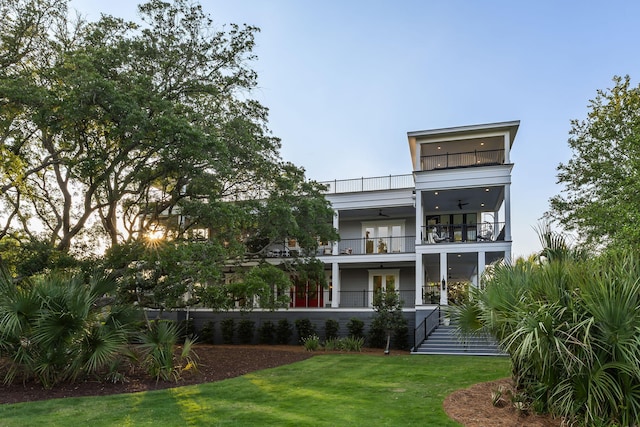 2213 Rolling Dune Rd, Seabrook Island, SC 29455 - back of house with a balcony, ceiling fan, french doors, a yard, and stairway