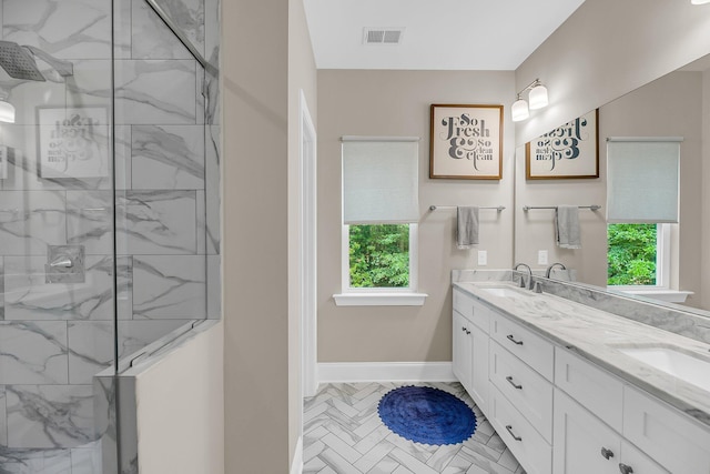 5725 Caviar Ct, Johns Island, SC 29455 - bathroom with double vanity, a marble finish shower, healthy amount of natural light, and baseboards