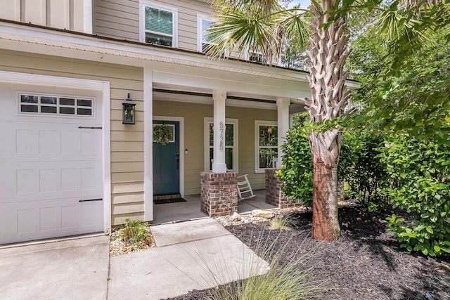 5725 Caviar Ct, Johns Island, SC 29455 - doorway to property with covered porch and a garage