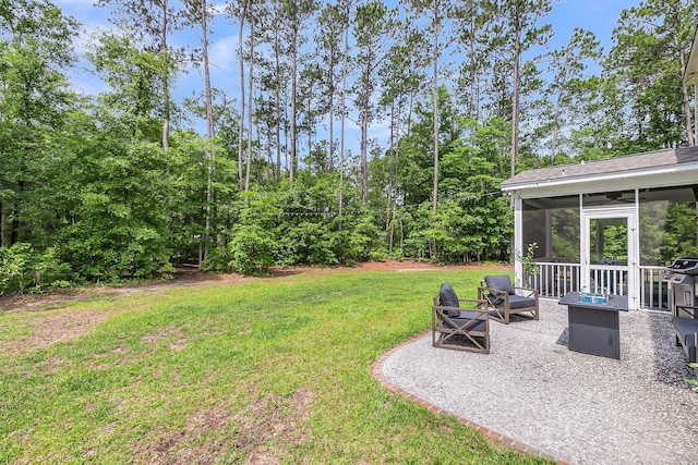 5725 Caviar Ct, Johns Island, SC 29455 - view of green lawn with a fire pit, a sunroom, and a patio area